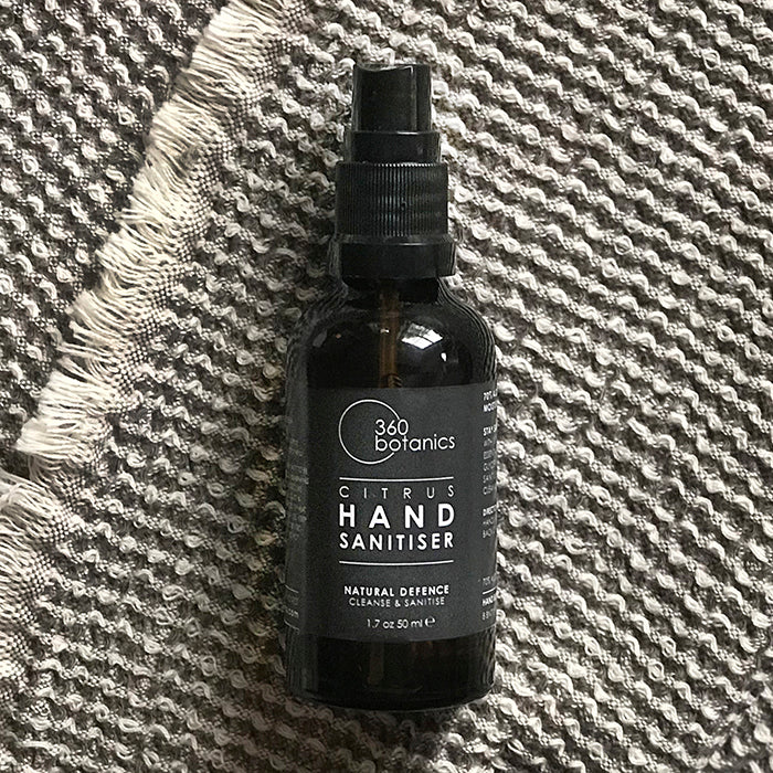 citrus hand sanitiser on grey fleck textured material