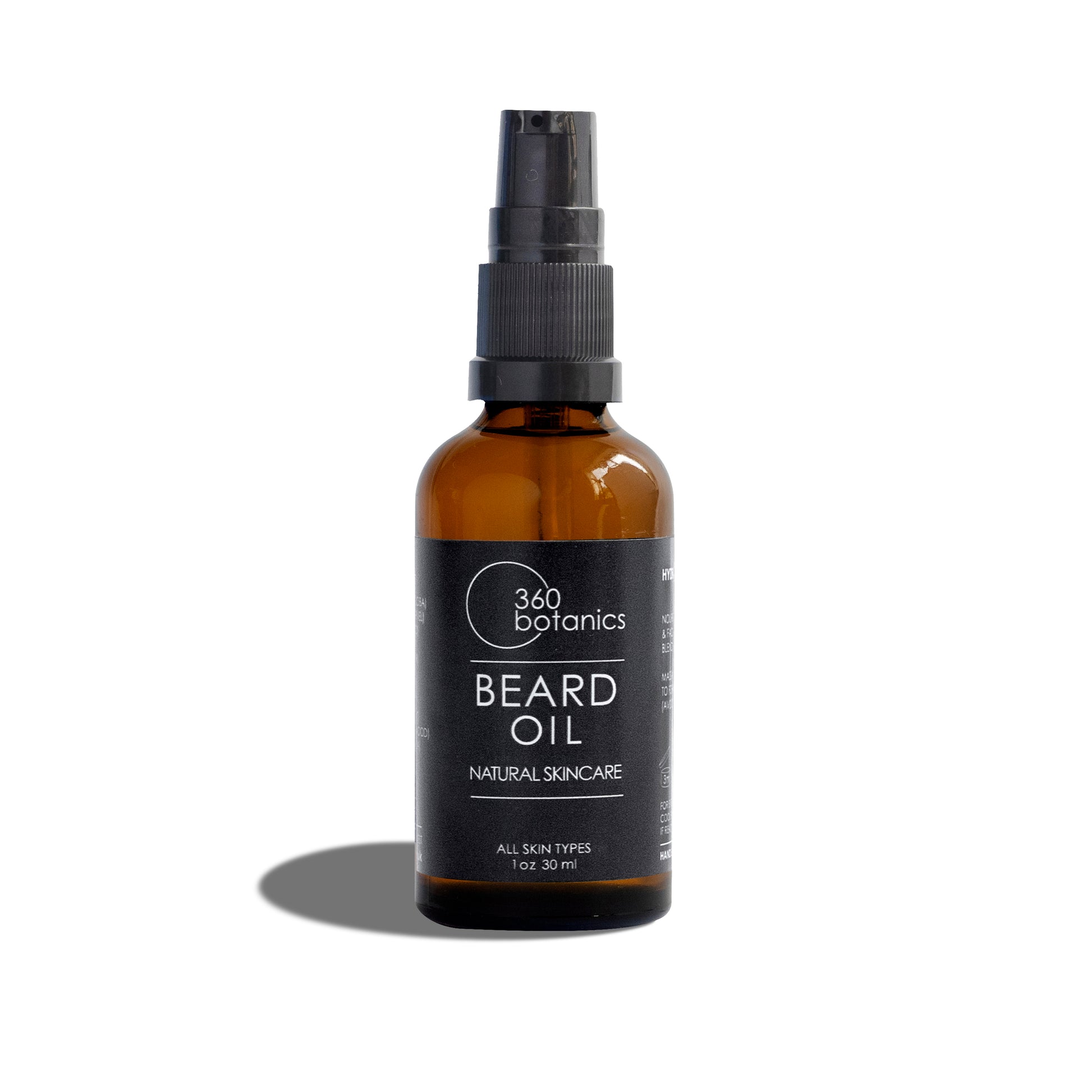 A 30 ml amber glass bottle of 360 Botanics Beard Oil with a black spray nozzle, prominently displayed against a white background. The label on the bottle indicates 'NATURAL SKINCARE' and 'ALL SKIN TYPES,' emphasising the product's suitability for a wide range of users and its natural ingredients
