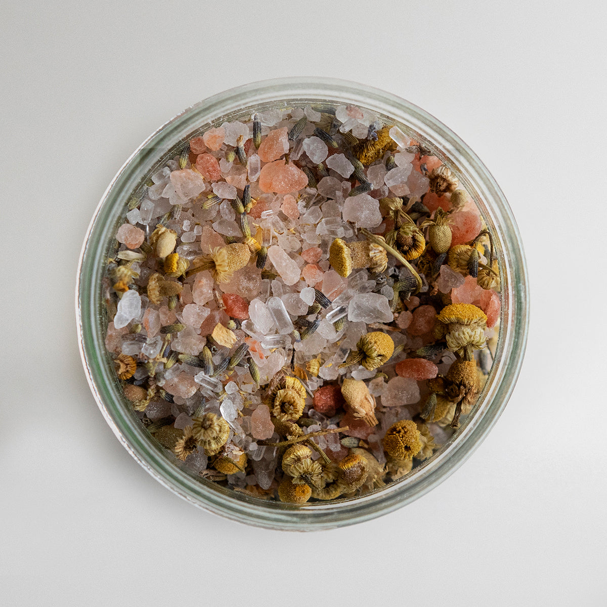 deep sleep bath salts open jar showing coloured slats on white background