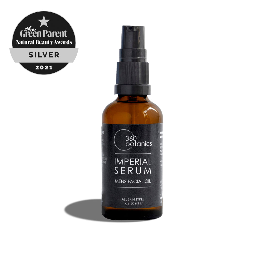 A 360 Botanics Imperial Serum men's facial oil bottle in amber glass with a black spray nozzle, featuring a label for all skin types. Above the bottle, a badge proclaims "The Green Parent Natural Beauty Awards SILVER 2021". The image has a white background with a soft shadow cast by the bottle.