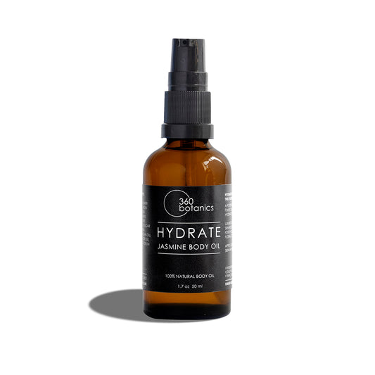  A 360 Botanics HYDRATE Jasmine Body Oil in an amber glass bottle with a spray pump, labeled in black and white, on a white background with a soft shadow to the right side of the bottle.