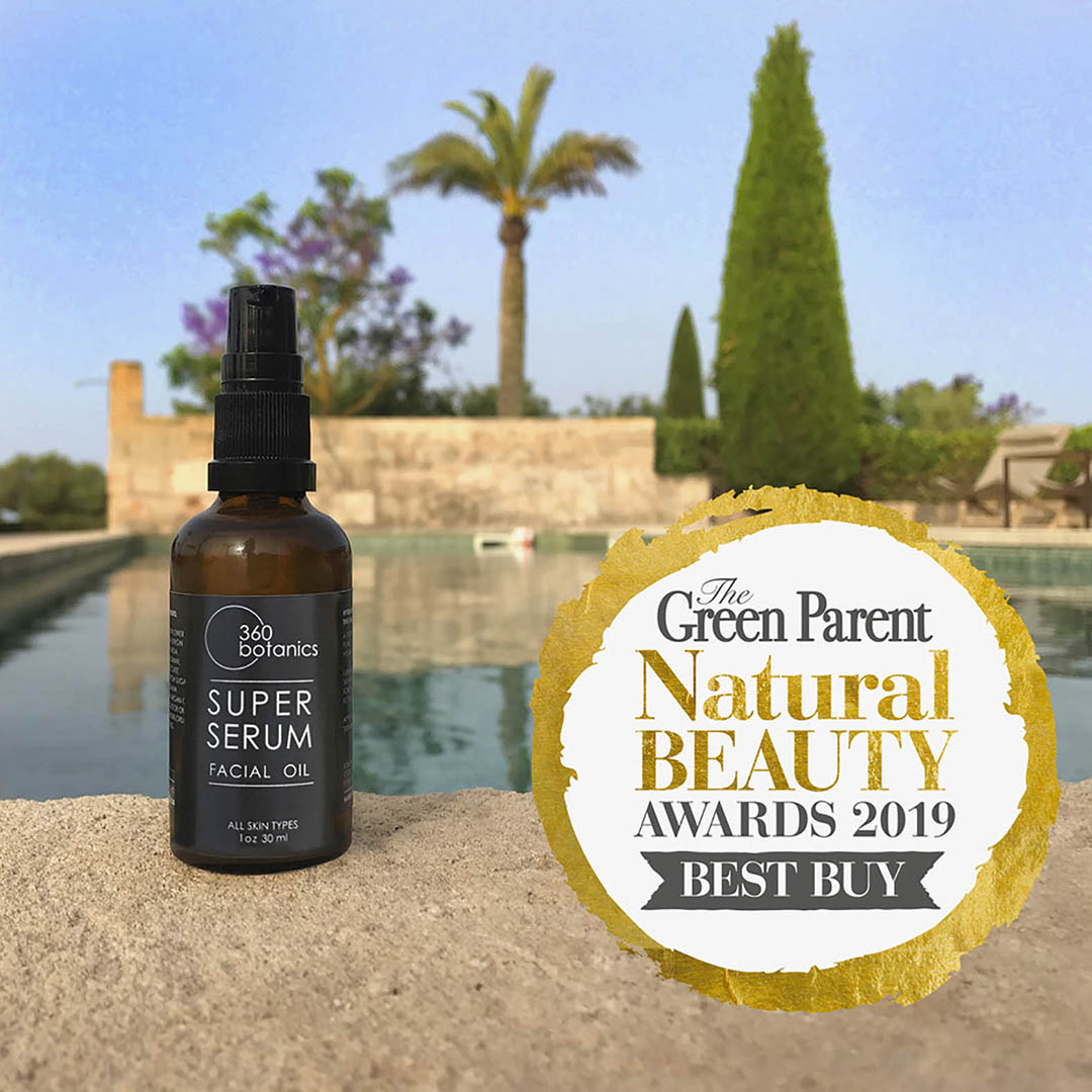 super serum amber glass bottle on stone floor, swimming pool in background, palm trees