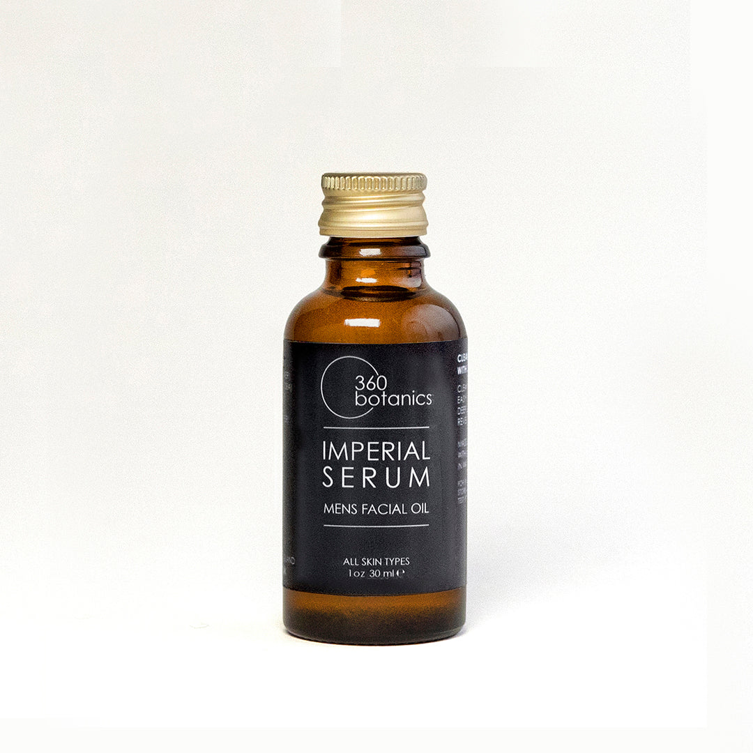  A 360 Botanics Imperial Serum men's facial oil in a small amber bottle with a gold cap and a black label, designed for all skin types, displayed against a white background.